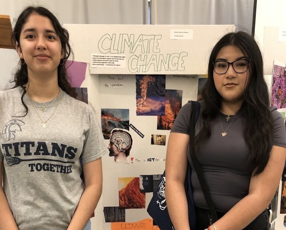 Dulce Lozano-Rea and Liliana Garcia, participants in the Casa San Jose teen program, stand with their posters at the Earth Day Community Resources Fair at St. Teresa of Kolkata Parish.