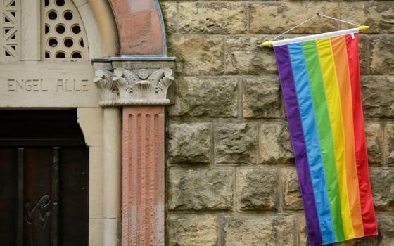 A rainbow flag is seen on the wall of a Catholic church in Cologne, Germany, May 10, 2021.
