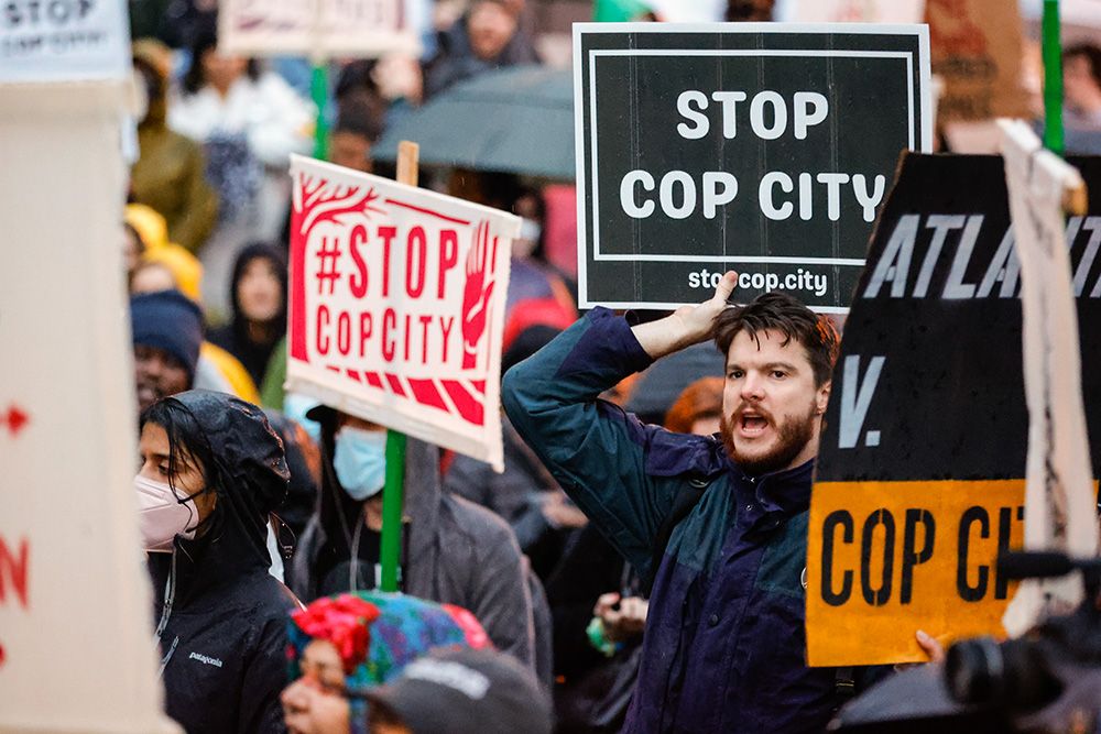 Demonstrators hold signs and chant slogans in Atlanta March 9, 2023, during a protest over plans to build a new police training center in public South River Forest. (AP/Alex Slitz)