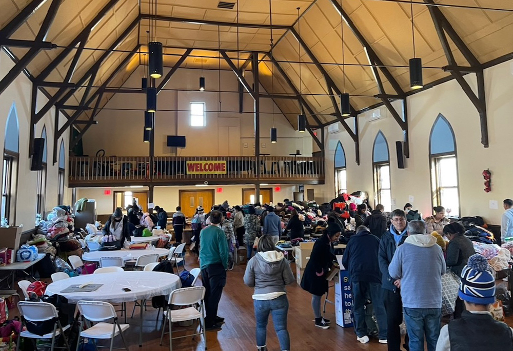 Migrants from a nearby encampment can take free clothes at the parish meeting hall of St. Thomas Aquinas Church in Brooklyn. (Courtesy of St. Thomas Aquinas Church)