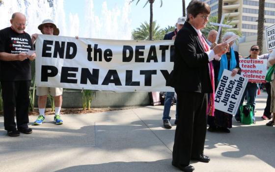 St. Joseph Sr. Helen Prejean speaks in front of a banner that reads, "End the death penalty."