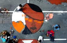 Climate change activists in San Francisco paint a mural during a protest outside of BlackRock headquarters Oct. 29, 2021, ahead of the 2021 U.N. Climate Change Conference. (CNS/Reuters/Nathan Frandino)
